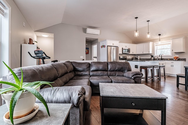 living area with vaulted ceiling, dark wood-style flooring, and a wall mounted AC