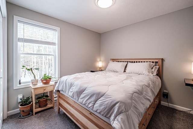 bedroom with carpet flooring and baseboards