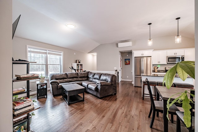 living area featuring vaulted ceiling, dark wood-type flooring, a wall unit AC, and baseboards