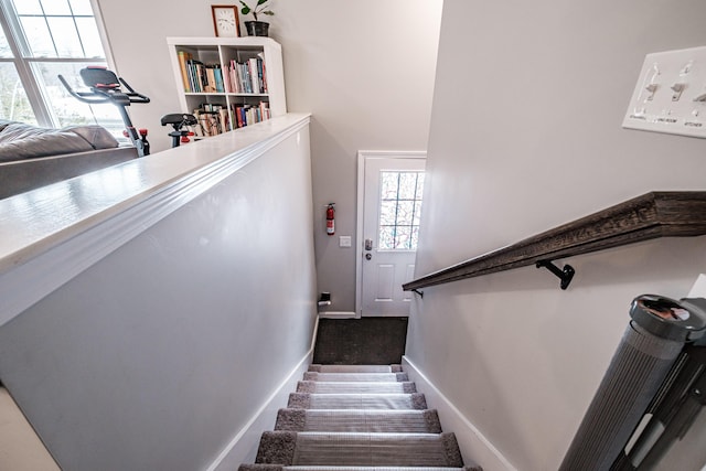 stairway featuring baseboards