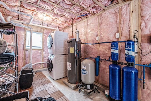 utility room with stacked washer and clothes dryer and electric water heater