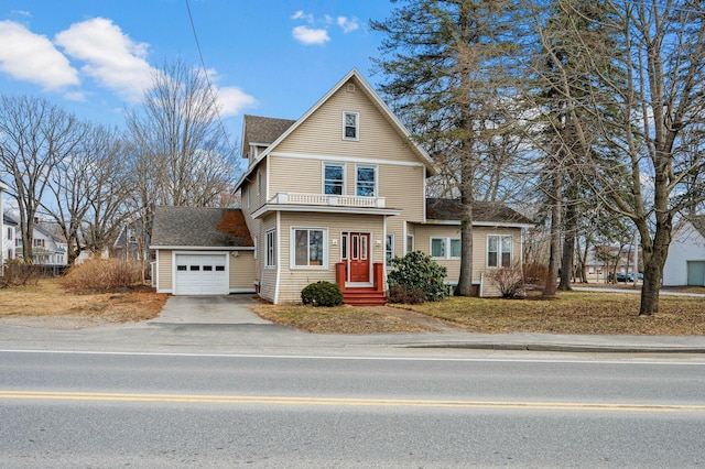 view of front of property with a balcony, a shingled roof, a garage, and driveway