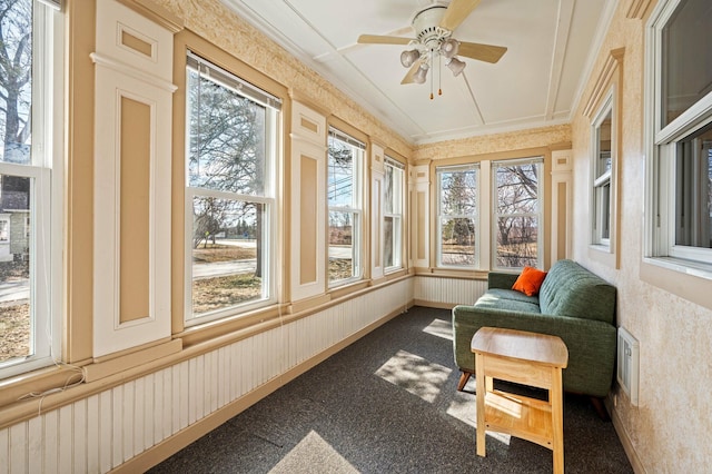 sunroom / solarium featuring wallpapered walls, crown molding, carpet flooring, and wainscoting
