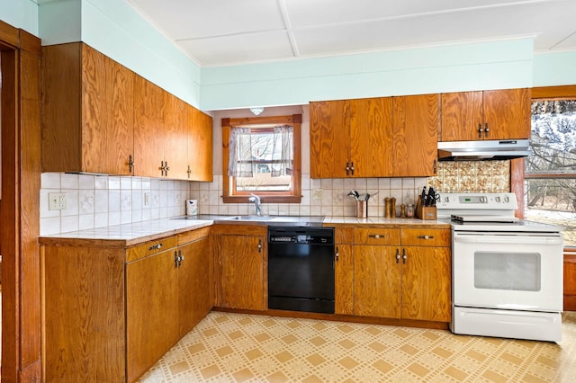 kitchen featuring white electric range oven, under cabinet range hood, decorative backsplash, black dishwasher, and brown cabinets