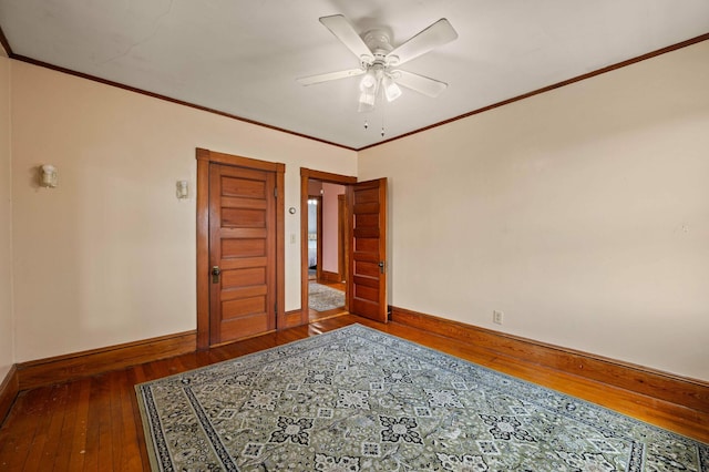 unfurnished room with baseboards, ceiling fan, ornamental molding, and wood-type flooring