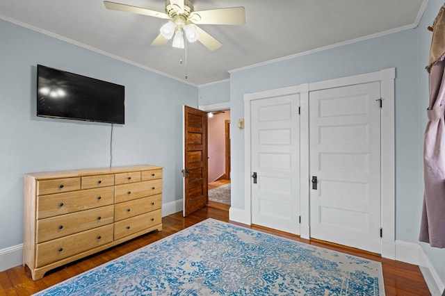 bedroom featuring baseboards, ceiling fan, wood finished floors, and crown molding