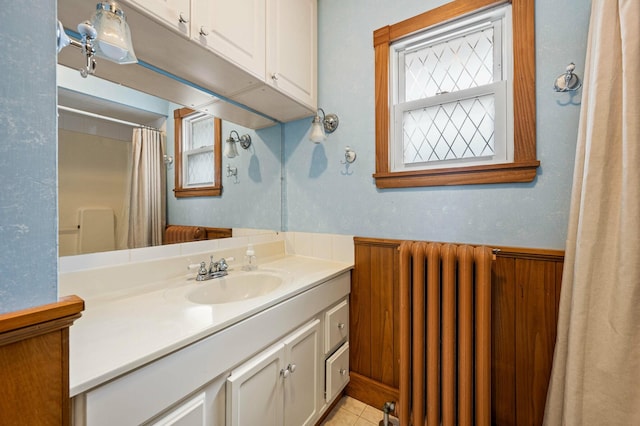 bathroom with radiator heating unit, tile patterned flooring, vanity, and a shower with shower curtain