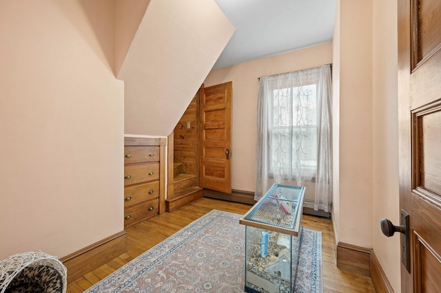 interior space with baseboards and wood finished floors
