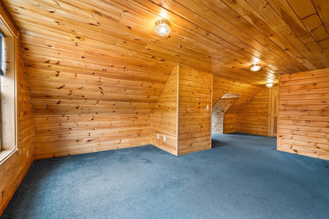 bonus room featuring lofted ceiling, carpet flooring, wood walls, and wood ceiling