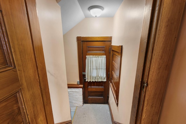 corridor featuring lofted ceiling