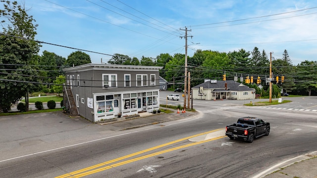 view of road featuring curbs, street lighting, and sidewalks