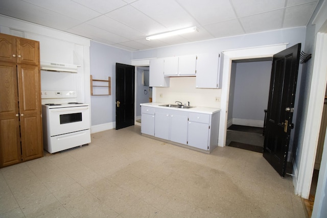 kitchen featuring light floors, white range with electric cooktop, light countertops, a sink, and under cabinet range hood