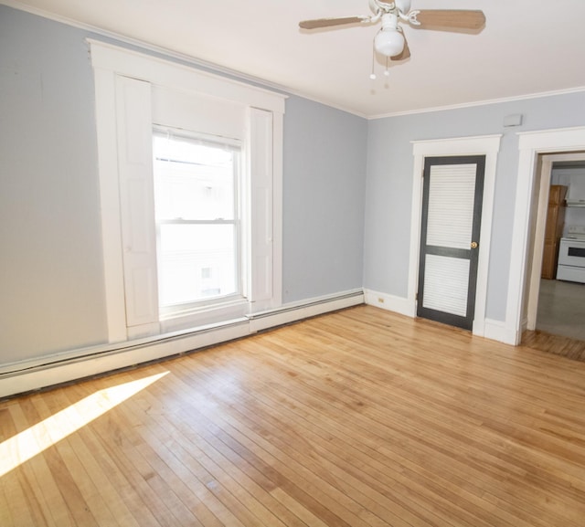 spare room with ornamental molding, light wood-type flooring, a baseboard radiator, and a ceiling fan