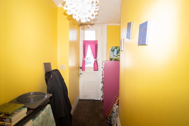 hallway with a notable chandelier