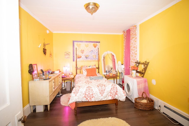 bedroom featuring a baseboard heating unit, crown molding, and wood finished floors