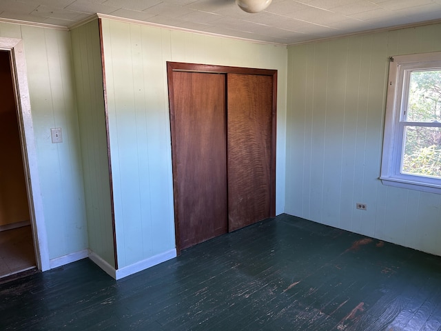 unfurnished bedroom featuring a closet and wood finished floors