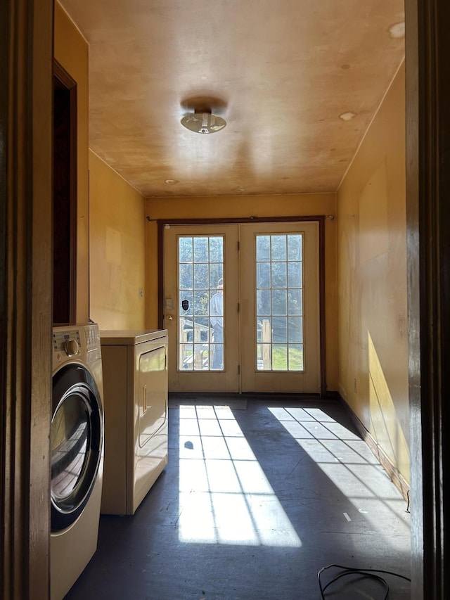 clothes washing area featuring separate washer and dryer