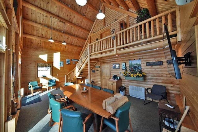 interior space featuring carpet, wooden ceiling, rustic walls, and beam ceiling