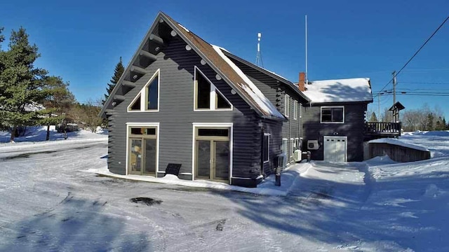 exterior space with log exterior and french doors