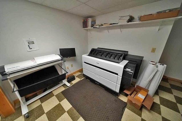 interior space with a drop ceiling, baseboards, and tile patterned floors