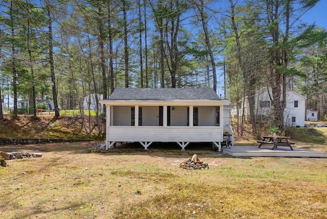 view of outbuilding with a fire pit