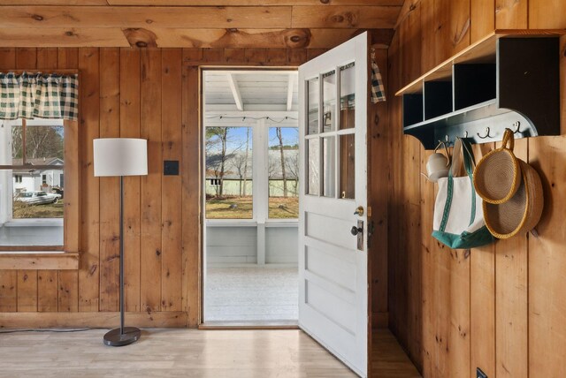 entryway with wooden walls, wood ceiling, and wood finished floors