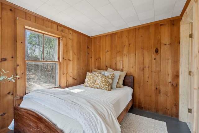 bedroom with wooden walls