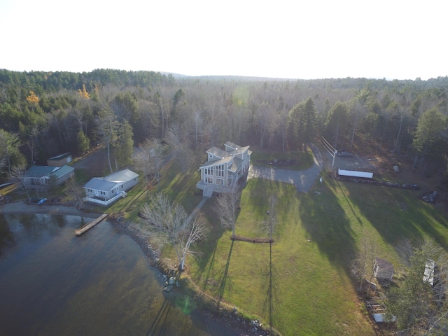 birds eye view of property with a wooded view