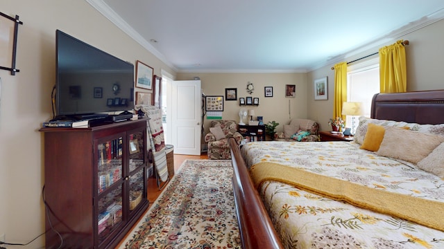 bedroom featuring wood finished floors and crown molding