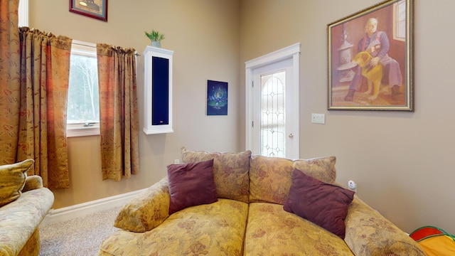 living area featuring carpet floors and baseboards