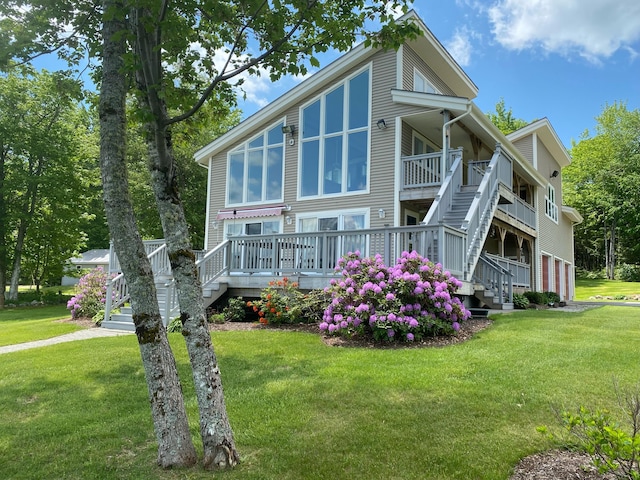 view of front facade featuring stairway and a front yard