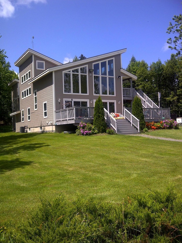 back of house with cooling unit and a yard