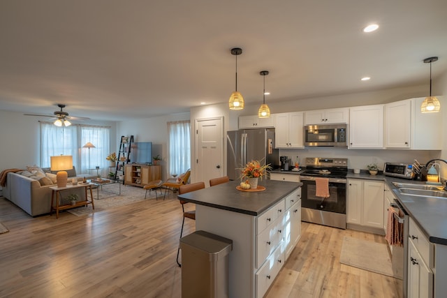 46 Firefly Ln, Bangor, ME 04401 - kitchen with appliances with stainless steel finishes, dark countertops, open floor plan, light wood-style flooring, and recessed lighting