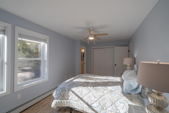 46 Firefly Ln, Bangor, ME 04401 - bedroom with a baseboard heating unit, wood finished floors, a closet, and a ceiling fan