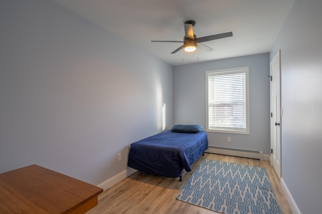 46 Firefly Ln, Bangor, ME 04401 - bedroom featuring a baseboard radiator, light wood-style flooring, and a ceiling fan