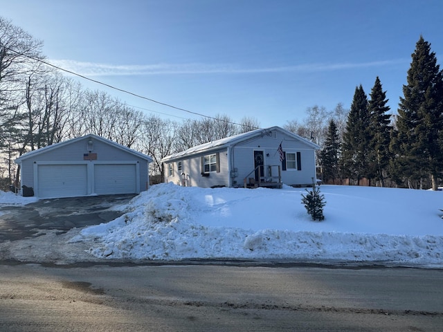 view of front of home featuring a garage and an outbuilding