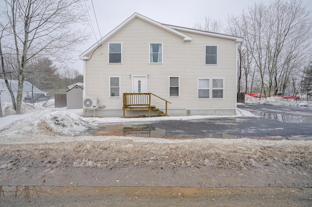 view of snow covered back of property