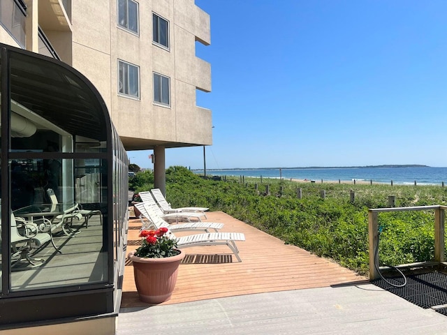 deck with a water view and a beach view