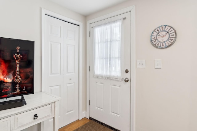 doorway to outside with light wood finished floors