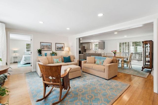 living room with light wood-style flooring and recessed lighting