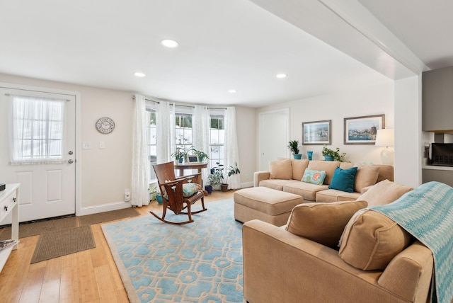 living area with recessed lighting, baseboards, and wood finished floors