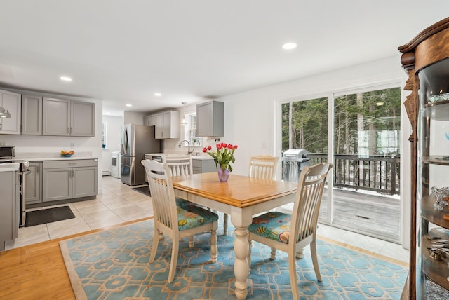 dining space with light tile patterned flooring and recessed lighting