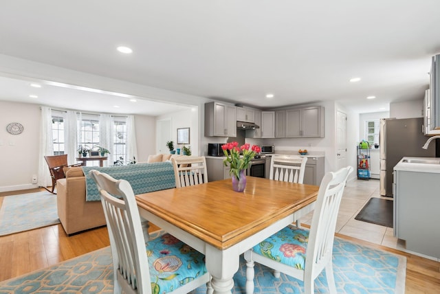 dining area featuring light wood-style flooring, recessed lighting, and baseboards