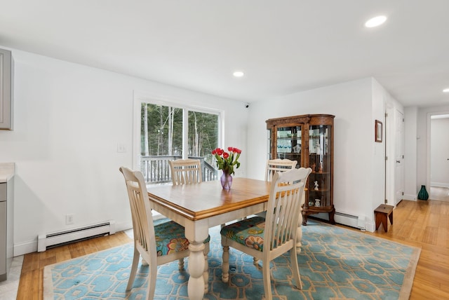 dining room featuring recessed lighting, light wood finished floors, and a baseboard radiator