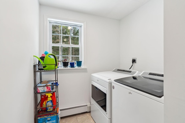 washroom featuring laundry area, washing machine and clothes dryer, light tile patterned flooring, and a baseboard radiator