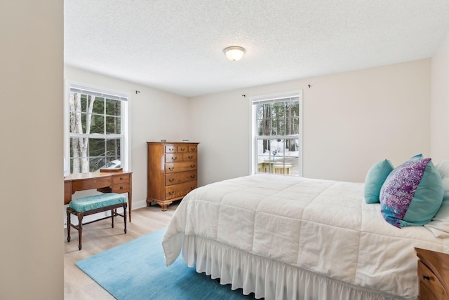 bedroom featuring a textured ceiling and wood finished floors