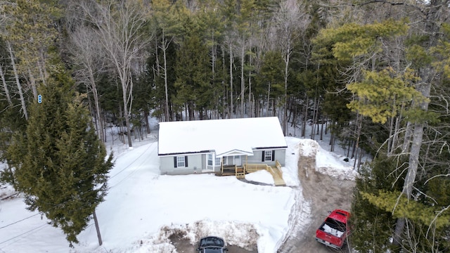 snowy aerial view featuring a view of trees