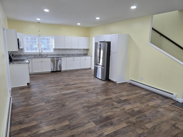 kitchen featuring appliances with stainless steel finishes, baseboard heating, a baseboard heating unit, white cabinetry, and a sink