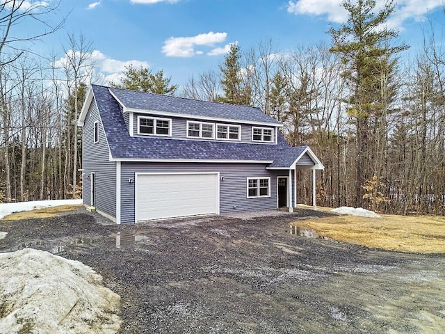 exterior space with a garage, roof with shingles, and dirt driveway