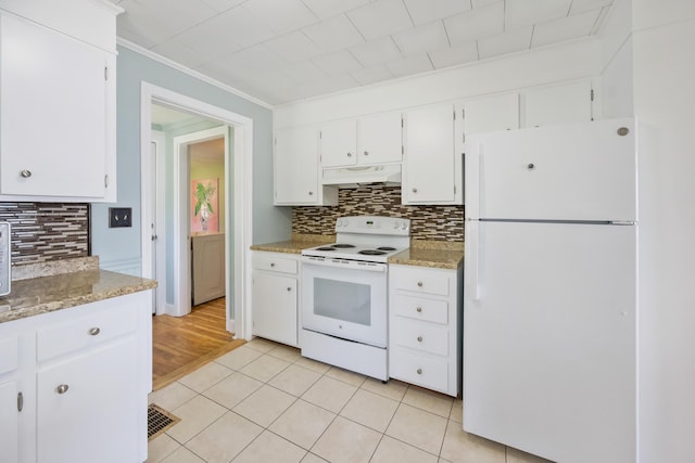 kitchen with light tile patterned floors, backsplash, white cabinets, white appliances, and under cabinet range hood